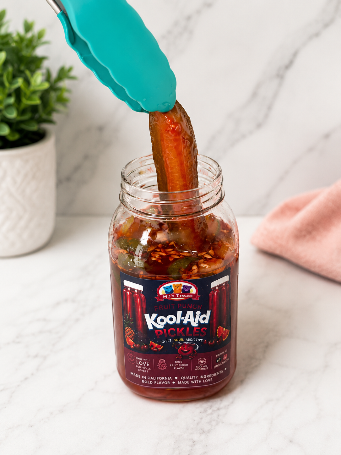 Fruit Punch Kool-Aid Pickles pickle being pulled out with tongs